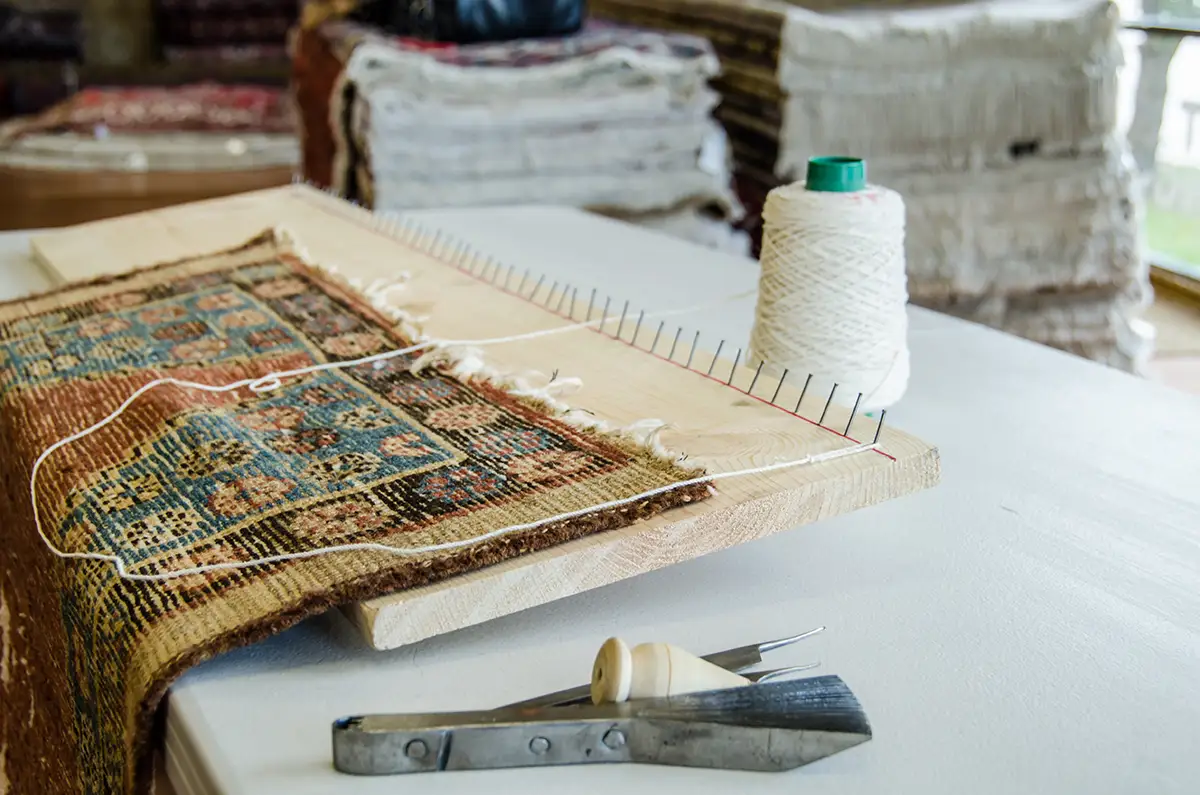 Rug repair and restoration on a loom